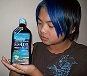 child holding fish oils