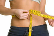 young woman measuring waistline